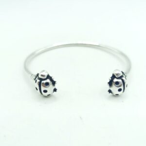 Pulsera rigida con mariquitas